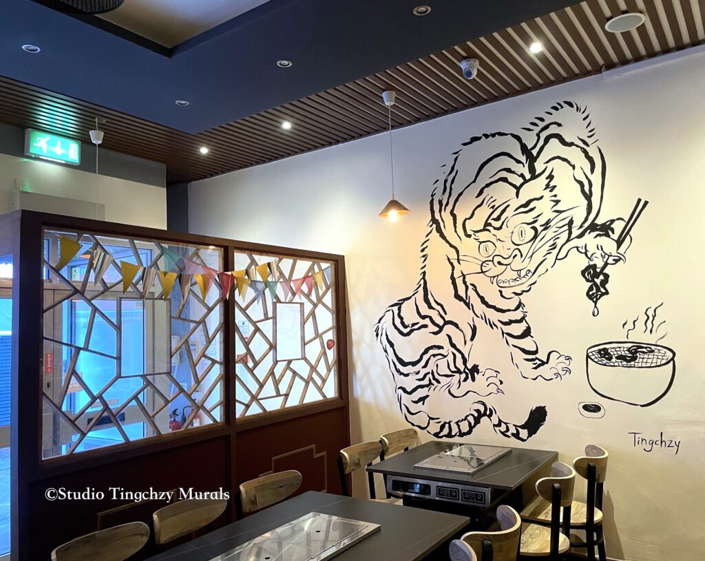 Tiger figure with ink painting in asian restaurant